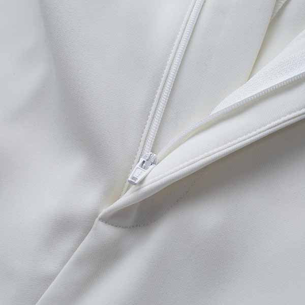 Close-up of Tucomosi women's wedding suit with feathers featuring a sleek white design and zipper detail