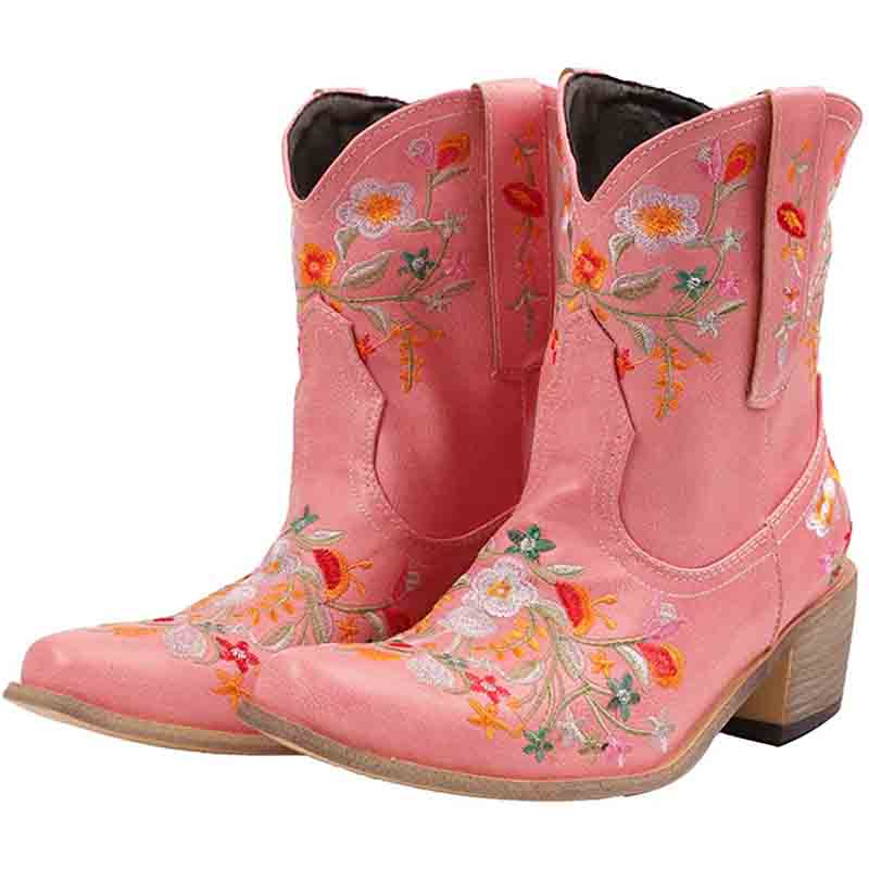 Vintage flower embroidered cowgirl boots in pink with colorful floral designs on the shafts