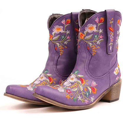 Vintage flower embroidered cowgirl boots in purple with colorful floral designs and a stylish heel