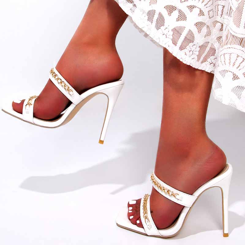 Elegant white wedding heels for summer bride with gold detailing and open-toe design