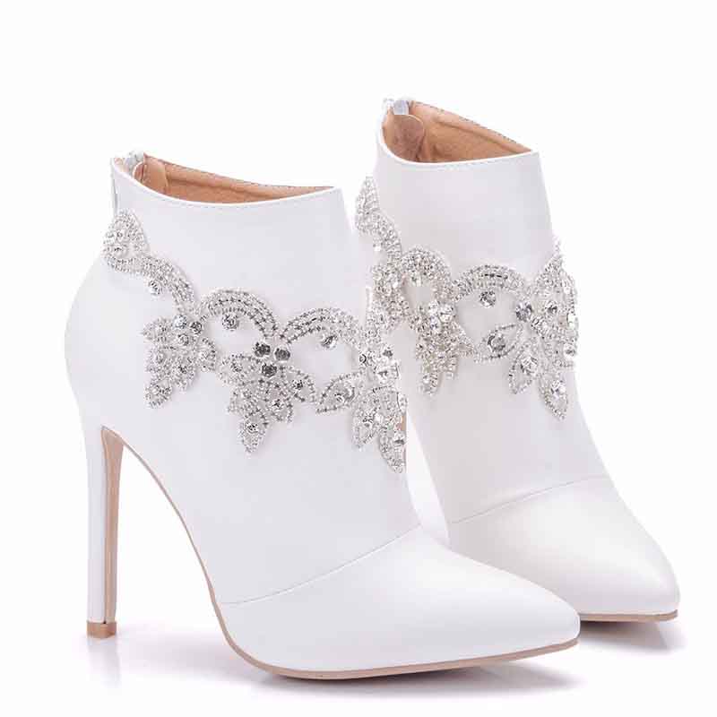 Elegant white ankle boots for women with decorative rhinestone embellishments and stiletto heels