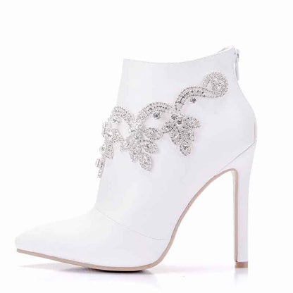 Elegant white ankle boots for women featuring intricate beaded floral embellishments and a stylish stiletto heel