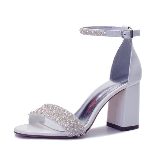 Elegant white high heel wedding shoes with pearl embellishments and ankle strap design