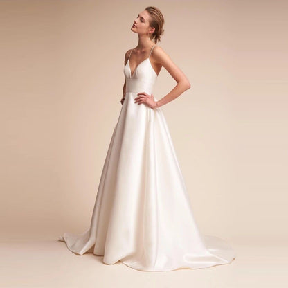 Elegant white slip wedding dress with a flattering V-neck and flowing skirt design for brides