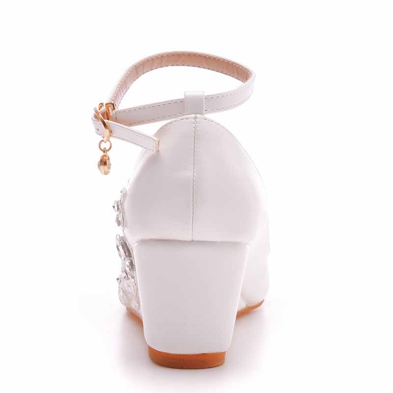 Back view of white wedge bridal sandals with a delicate ankle strap and decorative embellishments