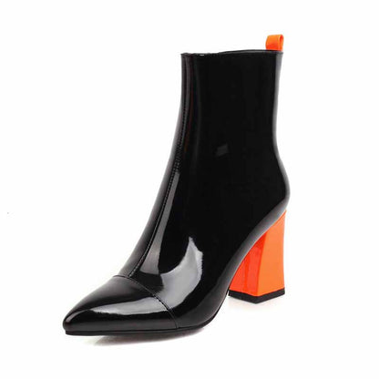 Women's block heel ankle boots in glossy black with vibrant orange heel and pointed toe design