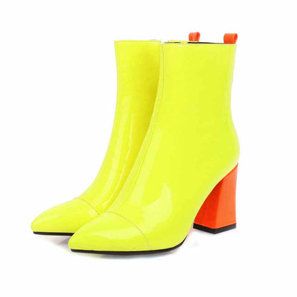 Women's block heel ankle boots in bright yellow with bold orange heel and sleek design