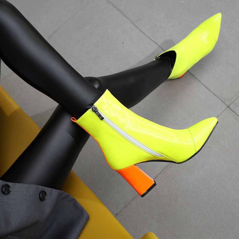 Women's block heel ankle boots in neon yellow with a stylish orange heel and zipper detail