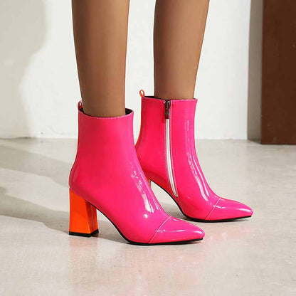 Women's block heel ankle boots in vibrant pink with shiny finish and orange accents