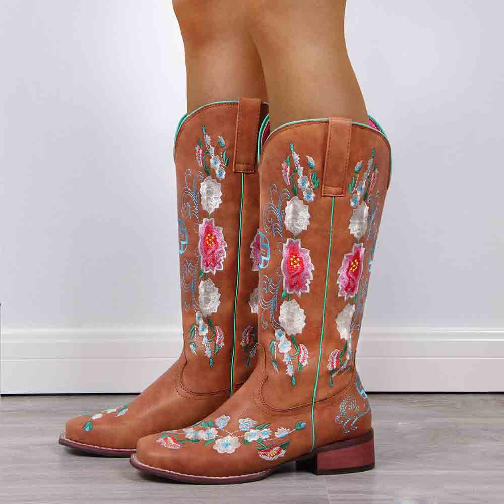 Women's embroidered cowboy boots in tan leather with colorful floral designs for a stylish western look
