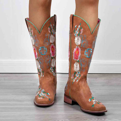 Stylish women's embroidered cowboy boots featuring colorful floral designs and a classic western silhouette