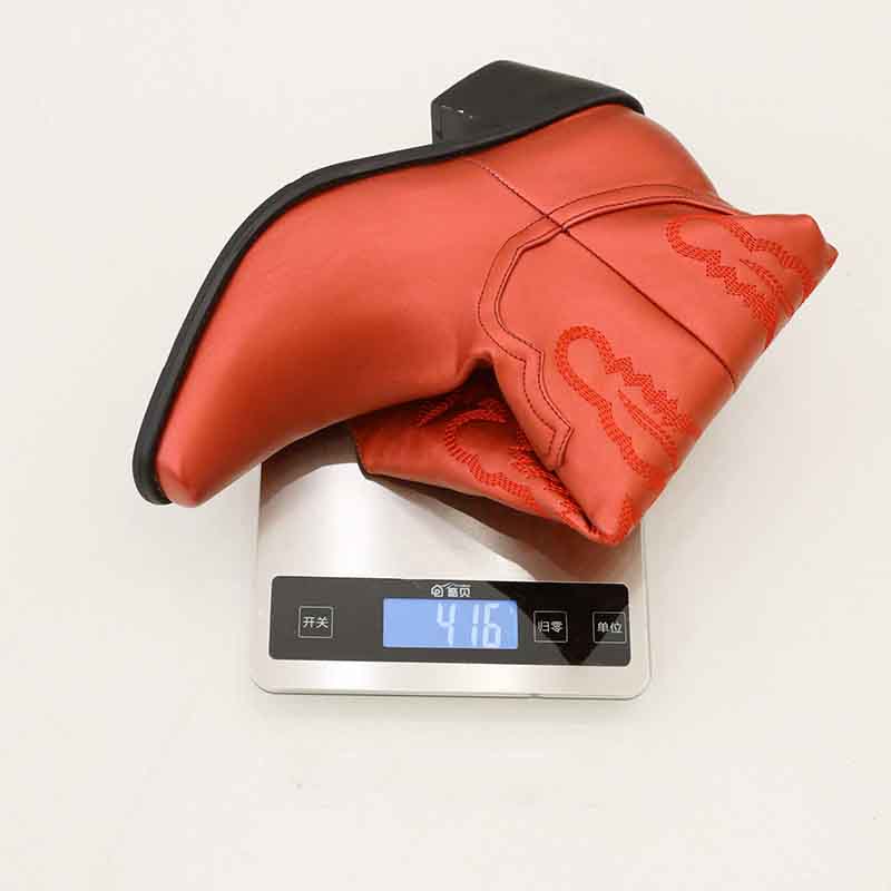 Red women's embroidered cowgirl boots on a digital scale displaying weight, showcasing detailed stitching