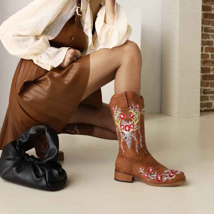 Stylish women's embroidered cowgirl boots in tan with floral designs, perfect for a trendy outfit