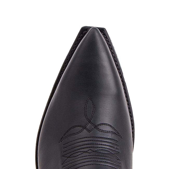 Close-up view of women's embroidered western boots with a sleek pointed toe and detailed stitching