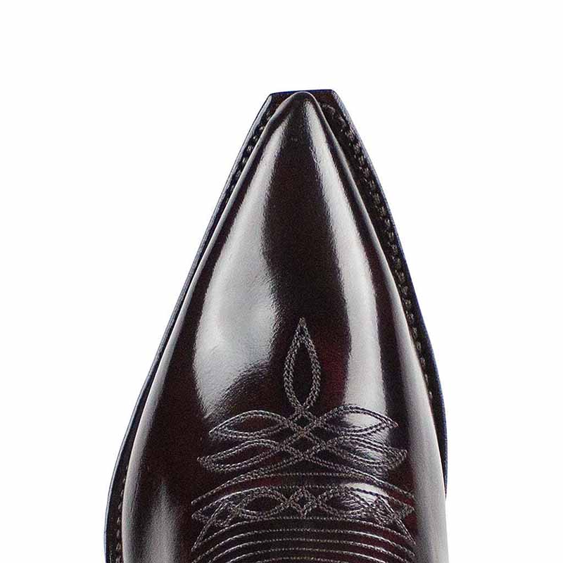 Close-up of women's embroidered western boots featuring intricate stitching and a pointed toe design