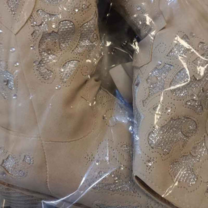 Close-up of women's glitter western wedding boots with intricate designs and sparkly embellishments