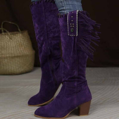 Stylish women's knee high cowgirl boots in purple with fringe details and a stacked heel