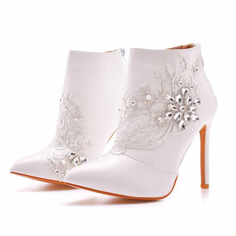 Women's lace wedding boots featuring intricate floral design and sparkling embellishments