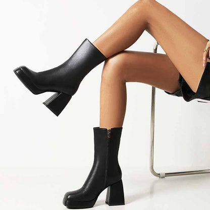 Stylish women's patent leather ankle boots with a sleek design and chunky heel