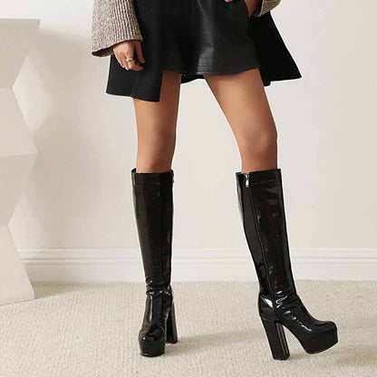 Stylish women's patent leather knee high boots with a chunky heel, perfect for trendy outfits