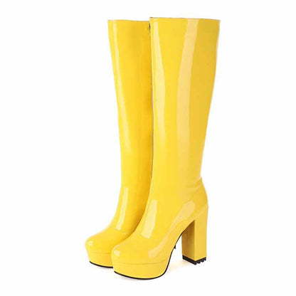 Stylish yellow women's patent leather knee high boots with a chunky heel for a bold fashion statement