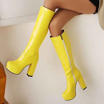 Stylish yellow women's patent leather knee high boots with a trendy design and platform heels