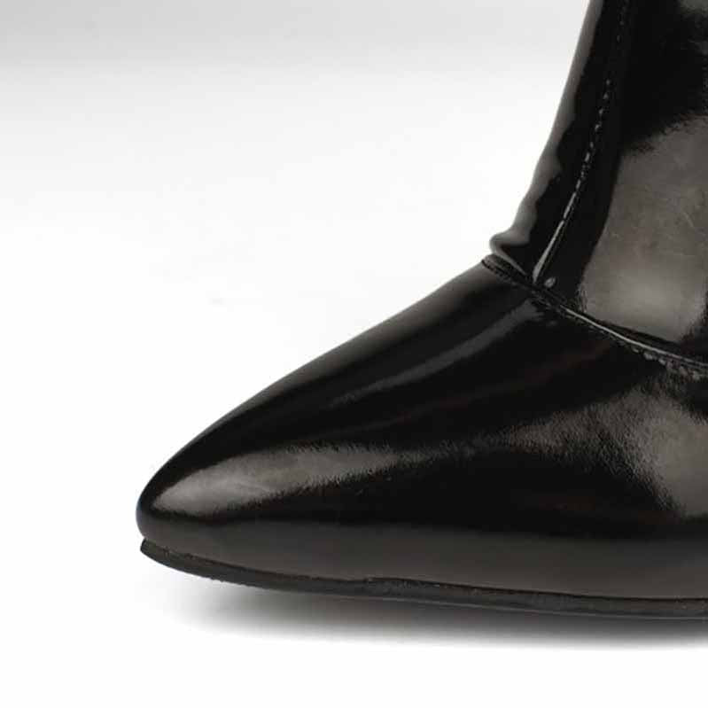 Close-up of women's patent leather thigh high boots with a pointed toe design and glossy finish