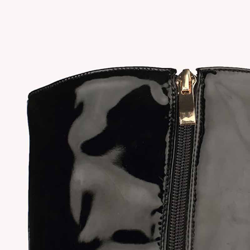 Close-up of women's patent leather thigh high boots with a sleek zip closure and shiny finish