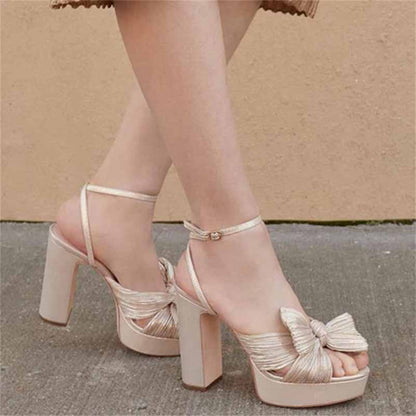 Elegant women's platform bow sandals in beige with ankle strap and chunky heel for weddings