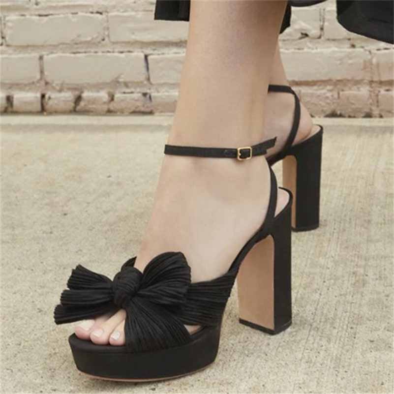 Black women's platform bow sandals with chunky heel and adjustable ankle strap for elegant occasions