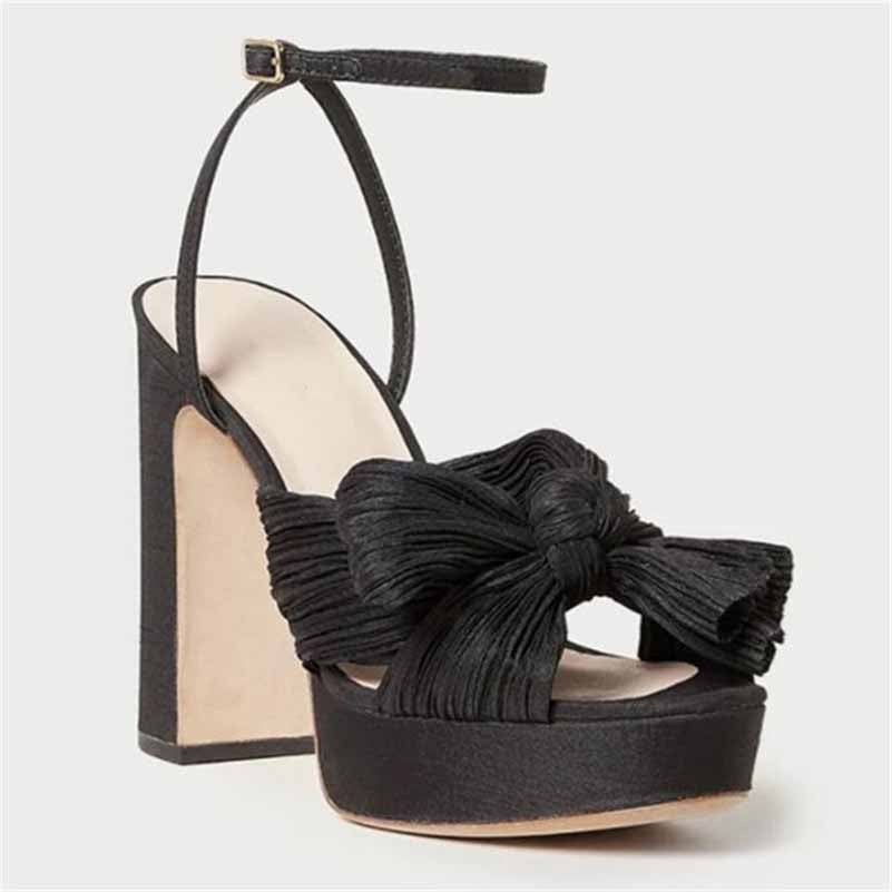 Elegant women's platform bow sandals in black with a stylish chunky heel and ankle strap for weddings
