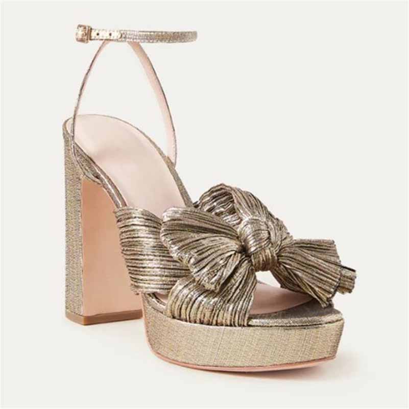 Elegant women's platform bow sandals in gold with a stylish ankle strap, perfect for weddings