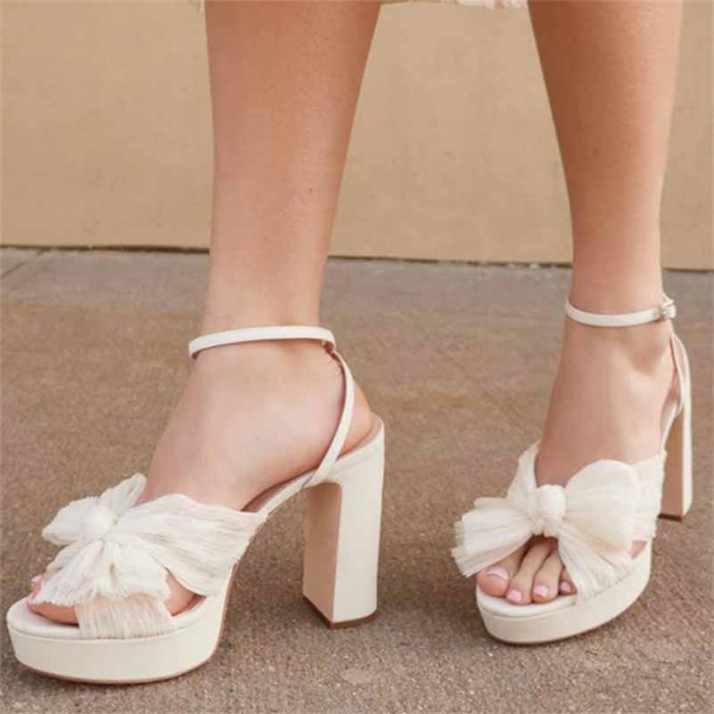 Stylish women's platform bow sandals in white with a trendy block heel for wedding occasions