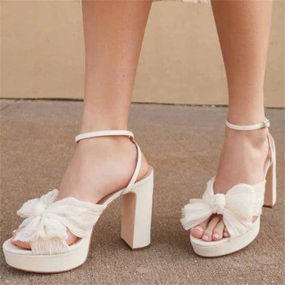 Stylish women's platform bow sandals in white with a trendy block heel for wedding occasions