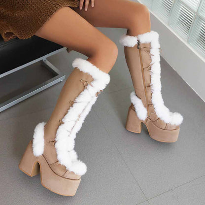 Stylish women's platform snow boots with fur trim and lace-up design for winter fashion