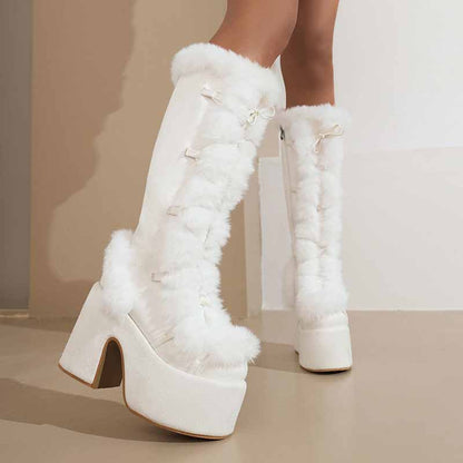 Stylish women's platform snow boots in white faux fur with chunky heels for winter fashion