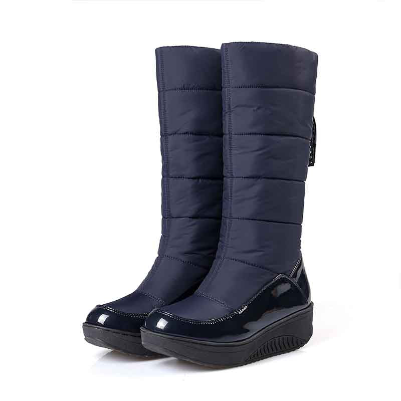 Women's waterproof snow boots in navy with a stylish puffy design and a comfortable wedge sole