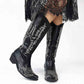 Stylish women's western cowboy boots with intricate silver stitching and low heel design