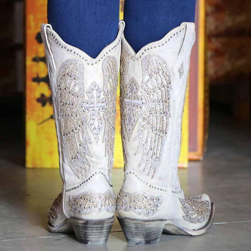 Women's white glitter wedding boots featuring intricate wing designs and decorative embellishments
