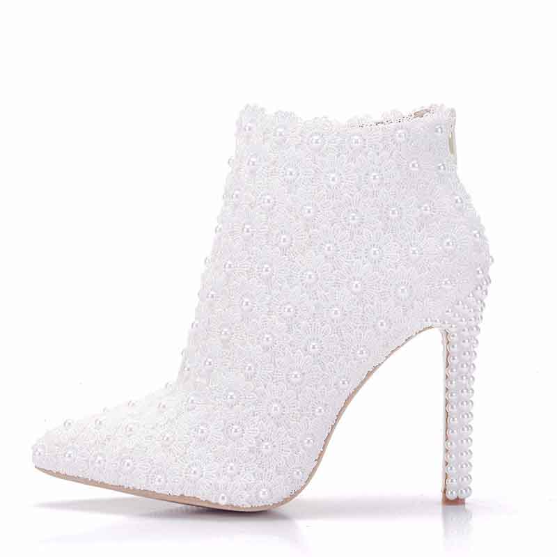 Stylish women's white wedding ankle boots adorned with pearls and a sleek stiletto heel
