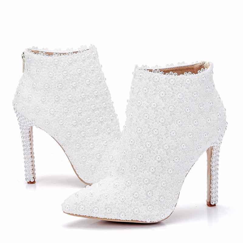 Stylish women's white wedding ankle boots adorned with elegant beading and a chic stiletto heel