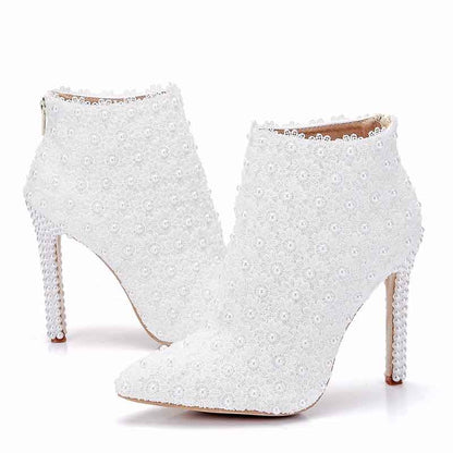 Stylish women's white wedding ankle boots adorned with elegant beading and a chic stiletto heel